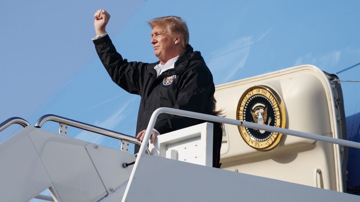 President Trump gestures to people cheering on the tarmac as he arrives in West Palm Beach, Fla. on March 8.