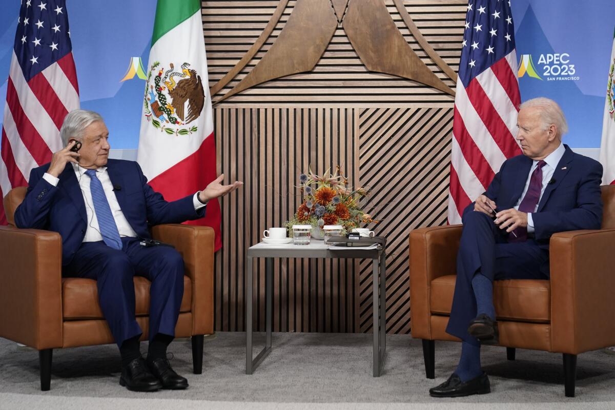 Mexican President Andrés Manuel López Obrador, left, and U.S. President Biden, sitting across from each other