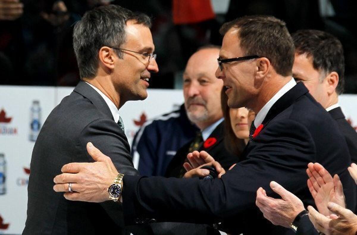 Scott Niedermayer, greeting former Devils teammate Scott Stevens (right), is honored before a game between the Toronto Maple Leafs and New Jersey on Friday night at the Air Canada Centre.