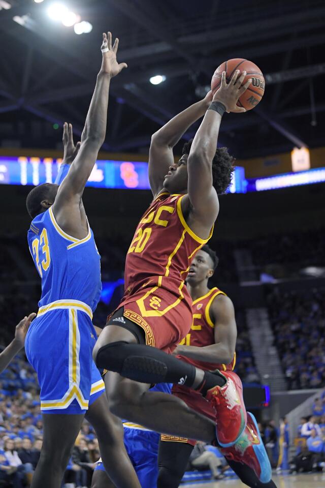 USC guard Ethan Anderson shoots as UCLA guard Prince Ali defends during the first half of a game Jan. 11 at Pauley Pavlion.