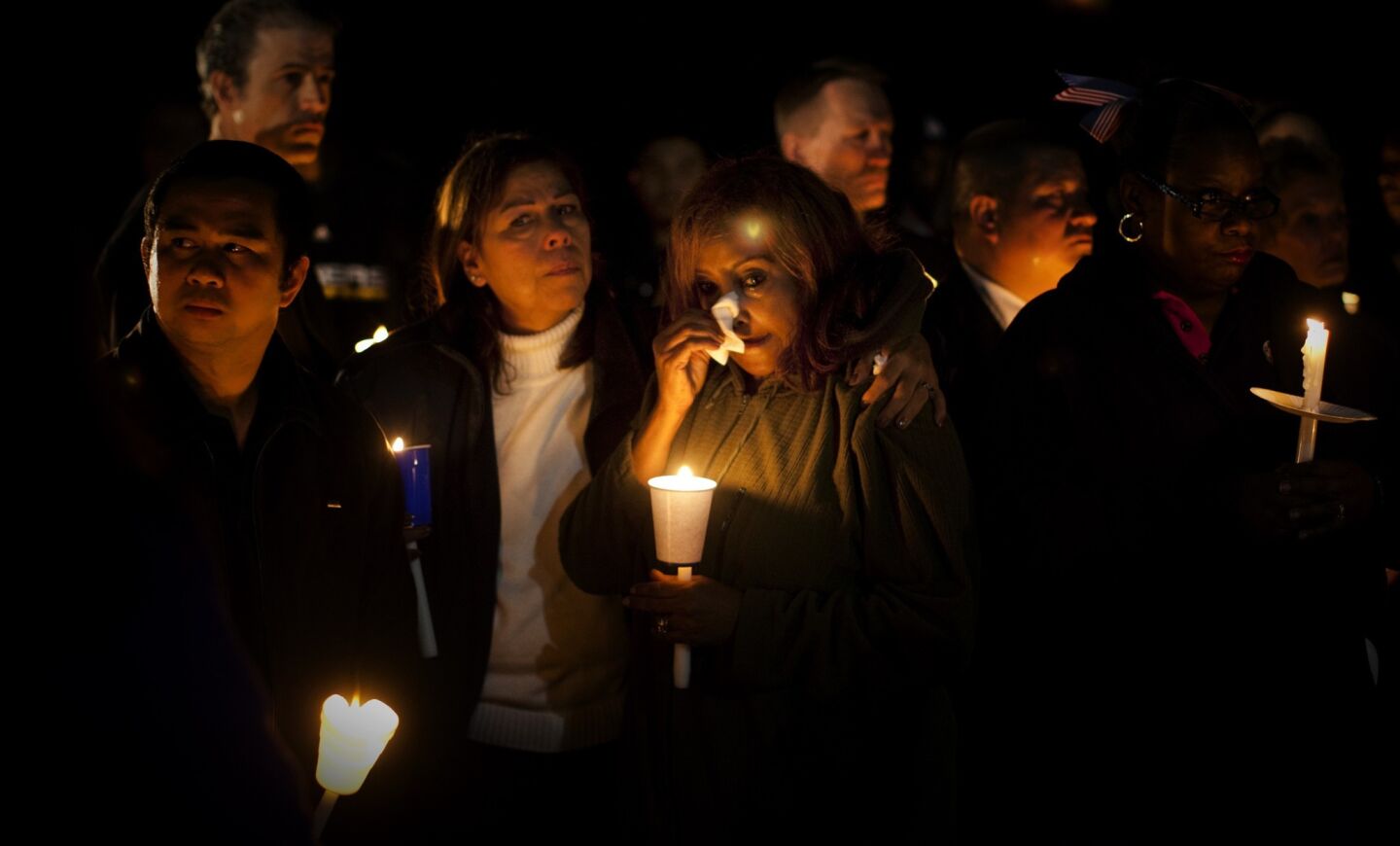 TSA agents Blandina Beltran,left, and Wessane Legesse, right, comfort each other at a candlelight vigil for their co-worker slain TSA agent Gerardo I. Hernandez at Dockweiler State Beach on November 4, 2013 in Los Angeles, California. Beltran and Legesse both work in Terminal 3 at LAX.