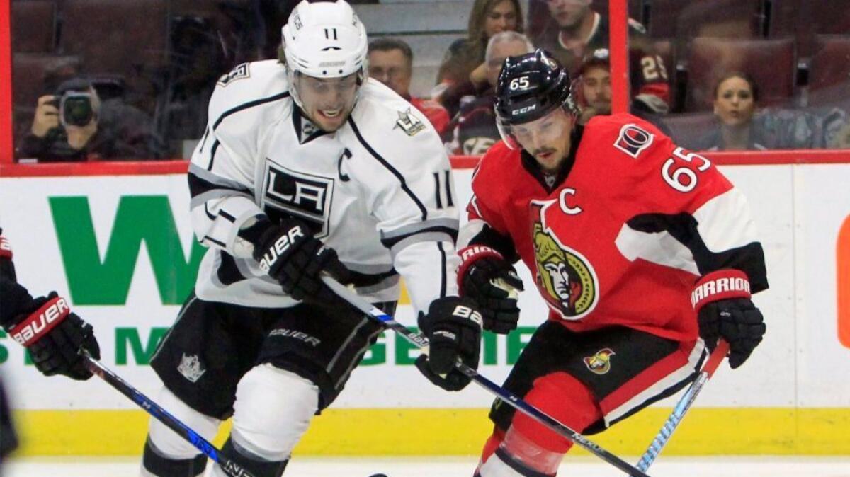 Kings forward Anze Kopitar battles with Ottawa Senators defenseman Erik Karlsson during the first period of a game on Nov. 11.
