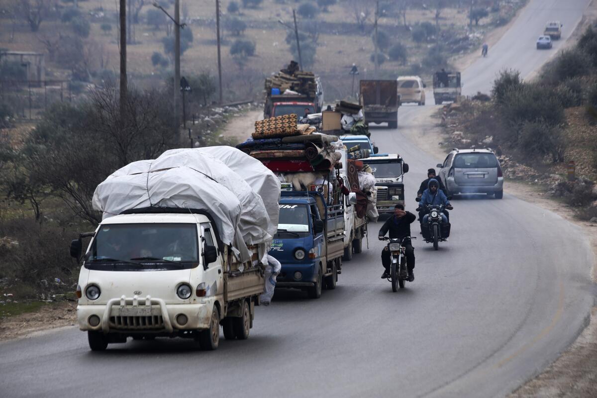 Syrians flee the town of Mastouma on Jan. 28 during a government offensive.