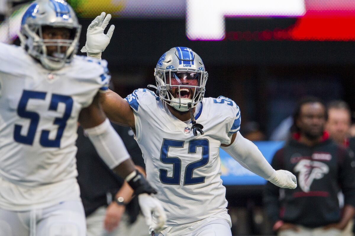 FILE - Then-Detroit Lions linebacker Jessie Lemonier (52) celebrates during the second half of an NFL football game against the Atlanta Falcons, Sunday, Dec. 26, 2021, in Atlanta. Outside linebacker Jessie Lemonier, who appeared in seven games for the Detroit Lions in 2021 in a brief NFL career highlighted by a sack of Aaron Rodgers of the Green Bay Packers, has died. He was 25. The Lions disclosed his death in a statement Thursday, Jan. 26, 2023, adding they confirmed it with his family. (AP Photo/Danny Karnik, File)