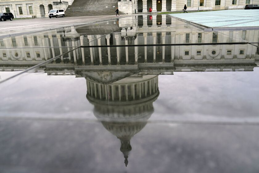 The reflection of the U.S. Capitol during a early rainy morning, is reflected in a skylight in Washington, Wednesday, March. 30, 2022, (AP Photo/Mariam Zuhaib)