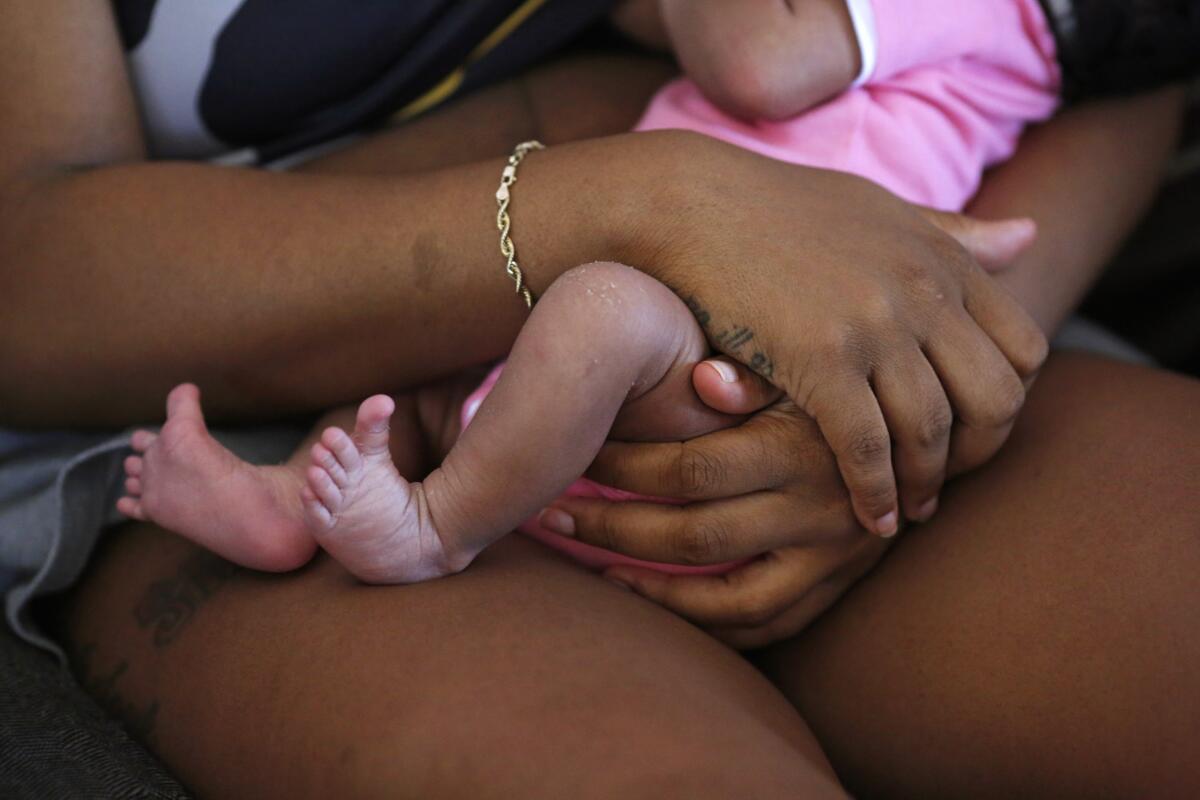 Aijalon Redd holds her baby girl Tori Davison one week after delivering her in May 2021 in Los Angeles.