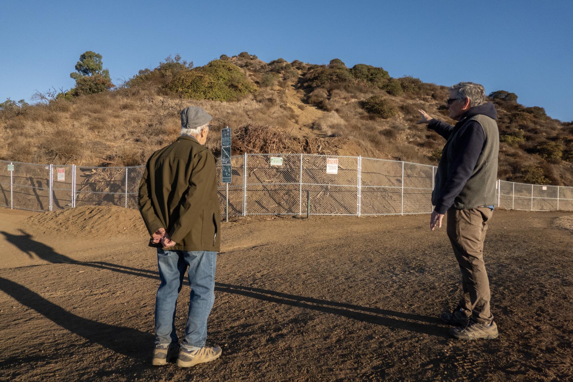 Hikers Pete Teti, left, and Tom McGovern are among those who are upset about fences on hiking trails at Griffith Park.