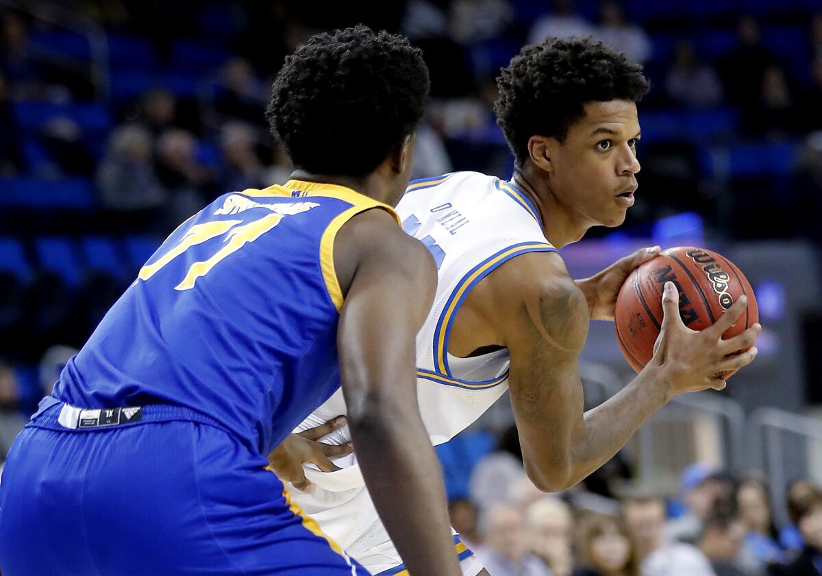 UCLA forward Shareef O'Neal looks for an open man inside while defended by San Jose State forward Christian Anigwe in the second half at Pauley Pavilion on Dec. 1, 2019.