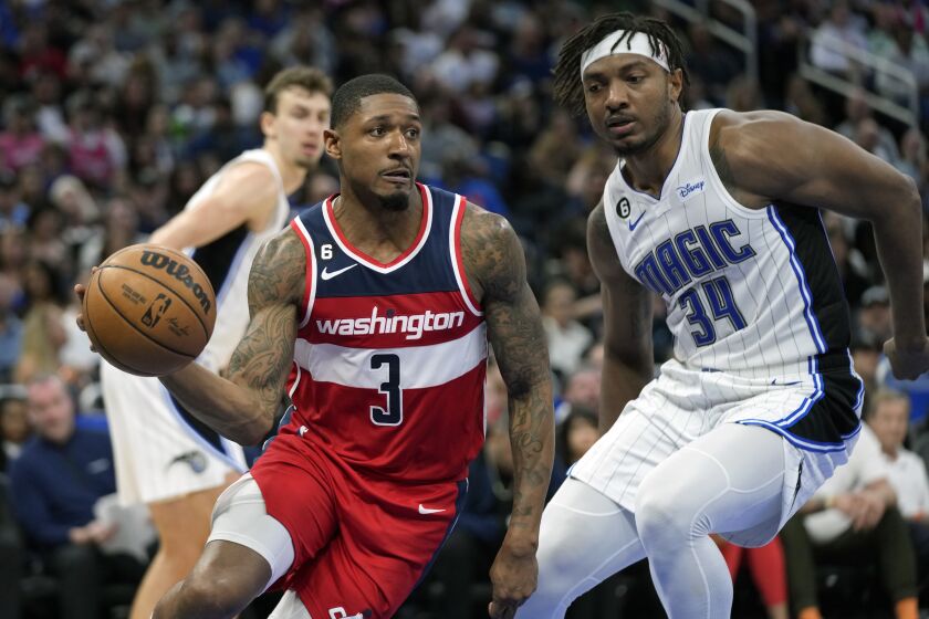 Washington Wizards' Bradley Beal (3) makes a move to get around Orlando Magic's Wendell Carter Jr. (34) during the second half of an NBA basketball game, Tuesday, March 21, 2023, in Orlando, Fla. (AP Photo/John Raoux)