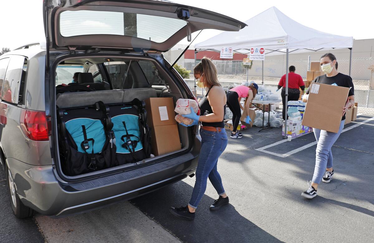 Volunteer Silvia Gomez, center, and case manager Lacy Morek