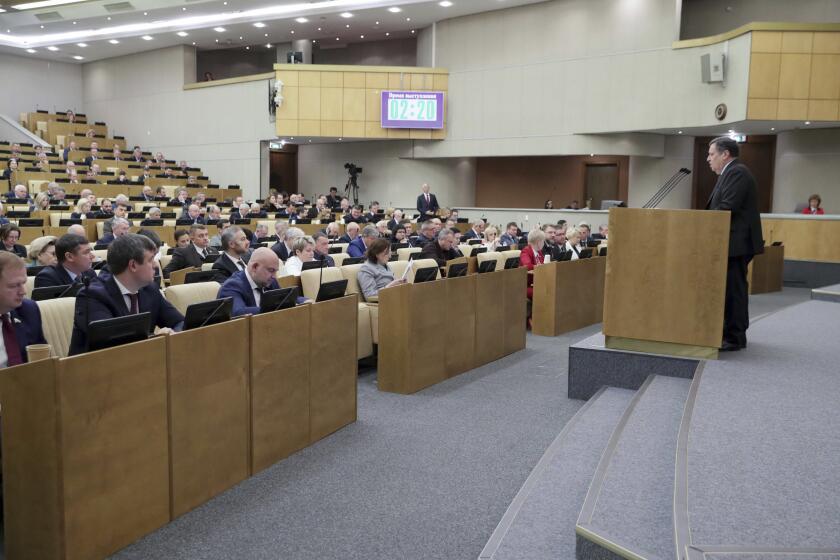 In this photo released by The State Duma, Russian lawmakers attend a session at the State Duma, the Lower House of the Russian Parliament in Moscow, Russia, on Friday, Nov. 17, 2023. The lower house of Russia's parliament, the State Duma, has passed a record federal budget which aims to increase spending by around 25% in 2024, with record amounts going to defense. (The State Duma, the Lower House of the Russian Parliament via AP)