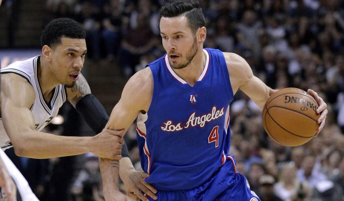 Clippers shooting guard J.J. Redick drives against Spurs guard Danny Green during the first half of Game 6.