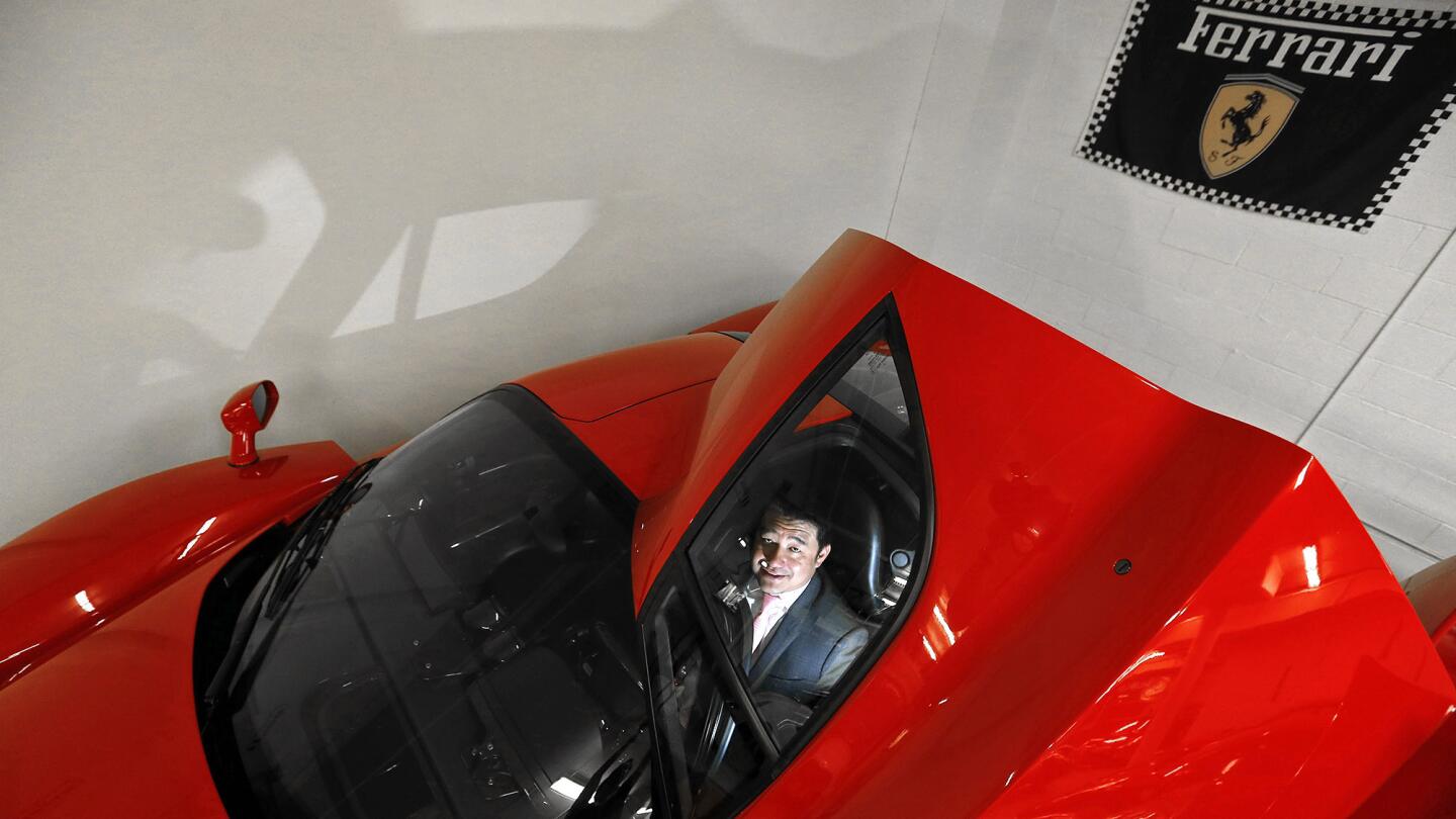 Ferrari collector David Lee sits in his 2003 Ferrari Enzo. He keeps a secret stash of Ferrari and other exotic cars in his Walnut garage Wednesday, Feb. 18, 2015.