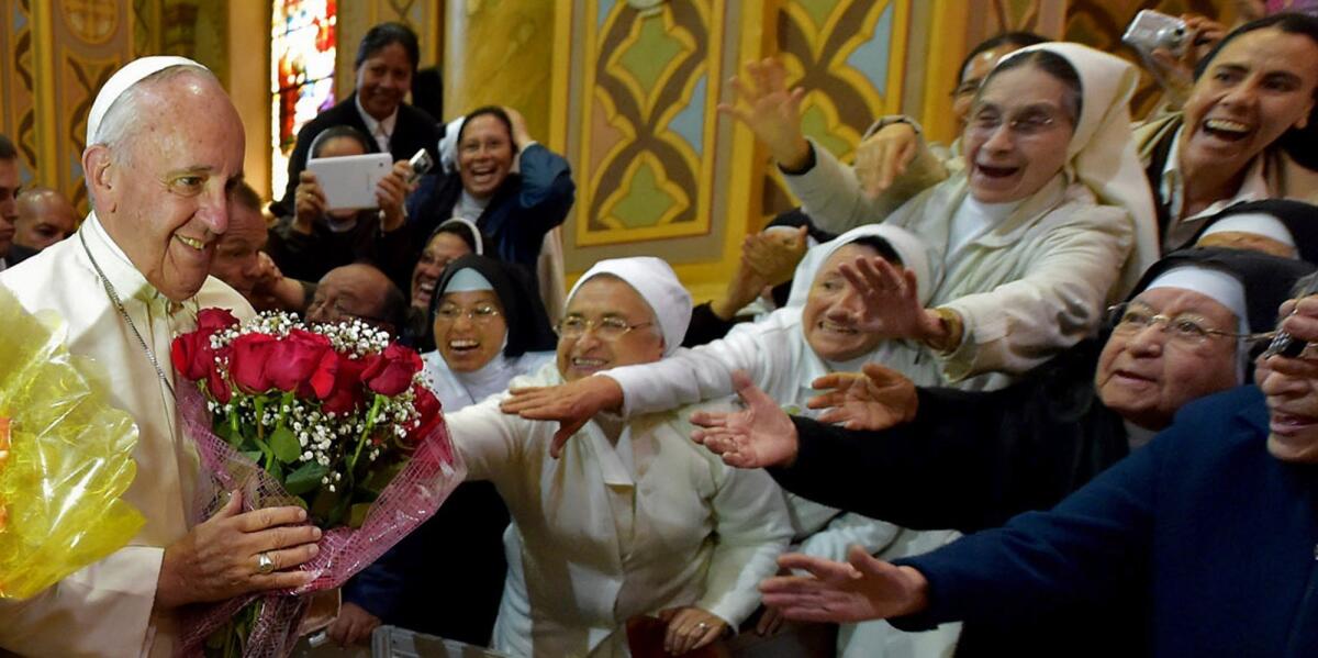 Nuns reach out to Pope Francis as he arrives at the National Shrine of Our Lady of the Presentation of El Quinche in Ecuador on July 8.
