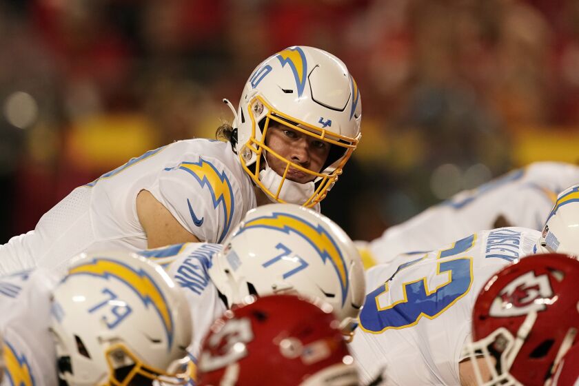 Los Angeles Chargers quarterback Justin Herbert under center during the first half of an NFL football game against the Kansas City Chiefs Thursday, Sept. 15, 2022, in Kansas City, Mo. (AP Photo/Charlie Riedel)