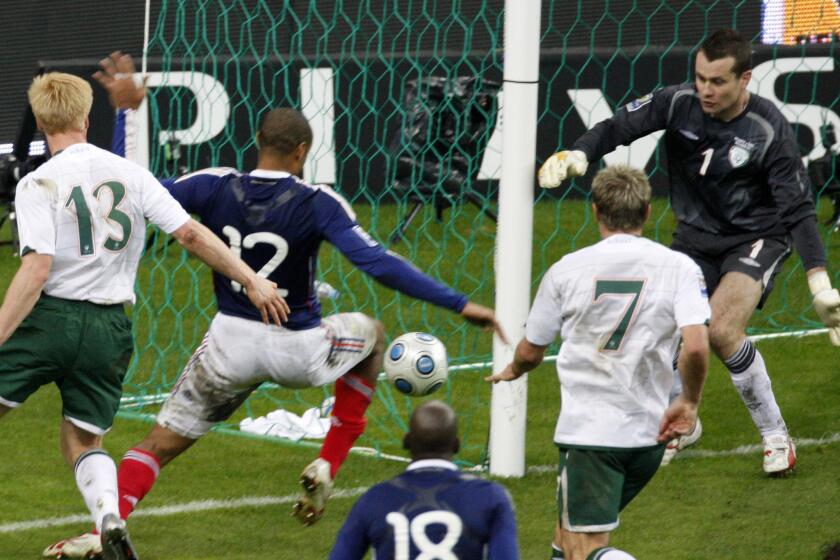 France's Thierry Henry, No. 12, left, passes the ball as Ireland's goalkeeper Shay Given tries to stop it, just before William Gallas (not pictured) scored the goal for France during their World Cup qualifying playoff match on Nov. 18, 2009.