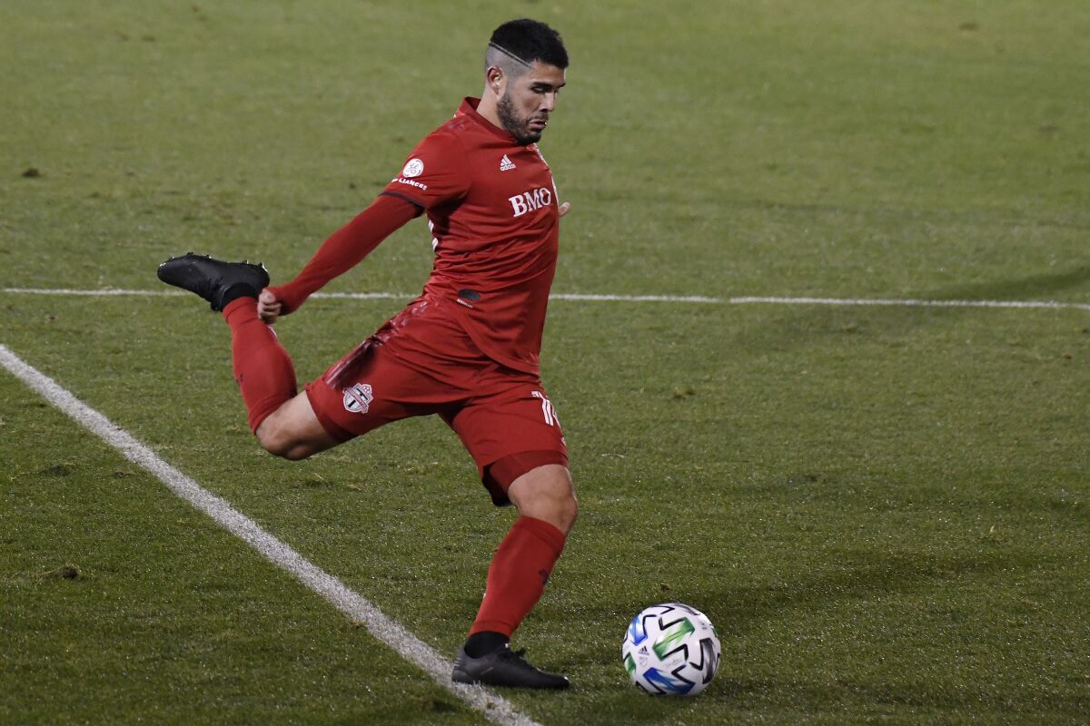 Toronto FC's Alejandro Pozuelo takes a shot on goal during overtime of the team's MLS soccer playoff match against Nashville SC, Tuesday, Nov. 24, 2020, in East Hartford, Conn. (AP Photo/Jessica Hill)