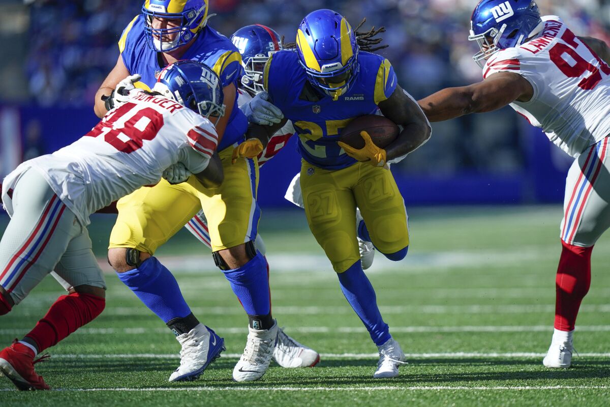 The Rams' Darrell Henderson finds a running lane against the Giants. He ran for 78 yards.