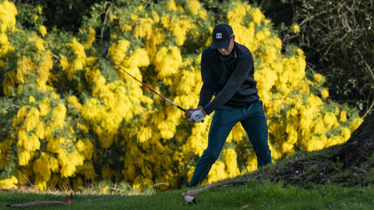 Co-leader Jordan Spieth hits out of the rough on the 13th hole during the first round of the Genesis Open at Riviera Country Club.