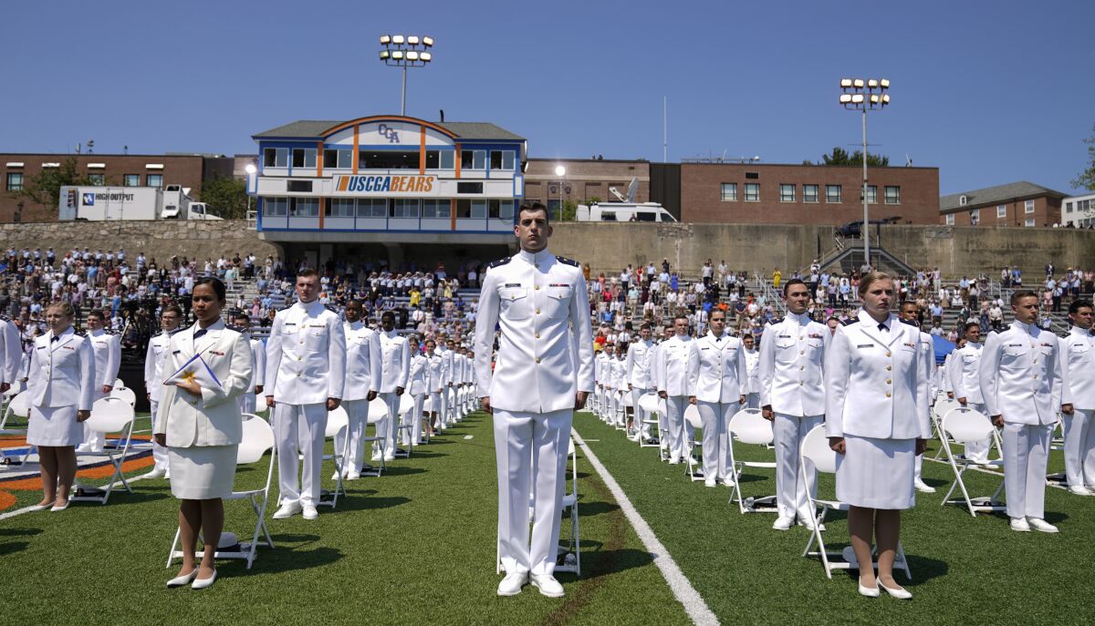 FILE - Cadets stand as President Joe Biden arrives to speak at the commencement for the United States Coast Guard Academy in New London, Conn., on May 19, 2021. A former cadet, not picture, who was expelled from the Coast Guard after becoming a father is challenging the school's policy that prohibits students from being parents in federal court. (AP Photo/Andrew Harnik, File)
