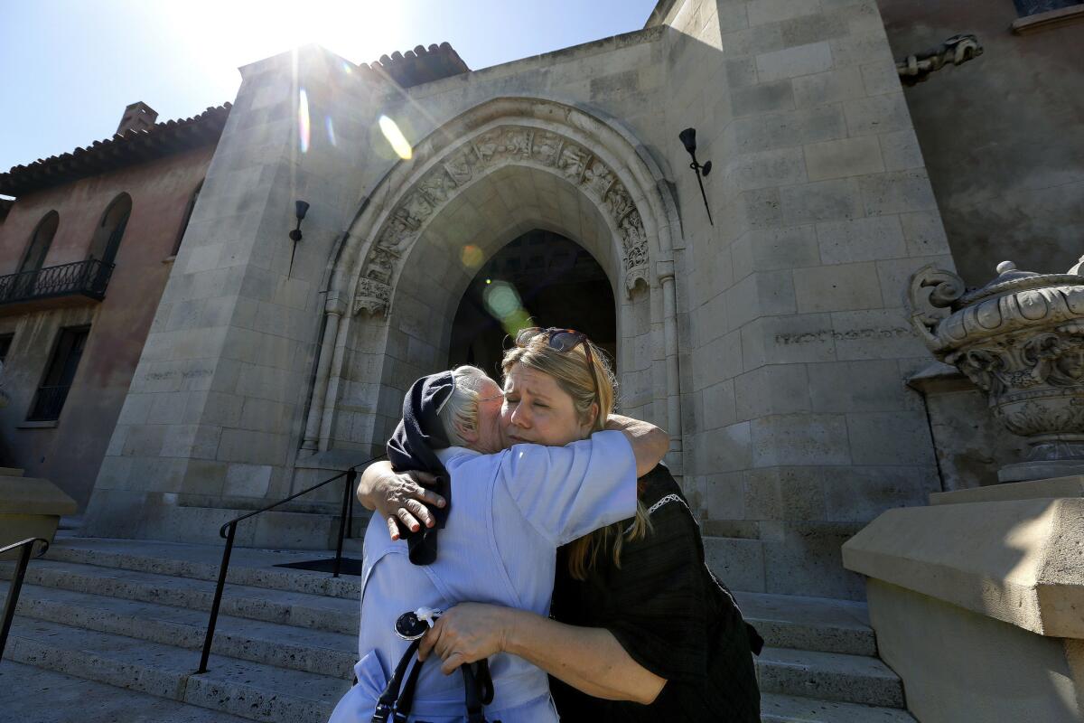 Sister Catherine Rose, 86, left, hugs restaurateur Dana Hollister on June 25.