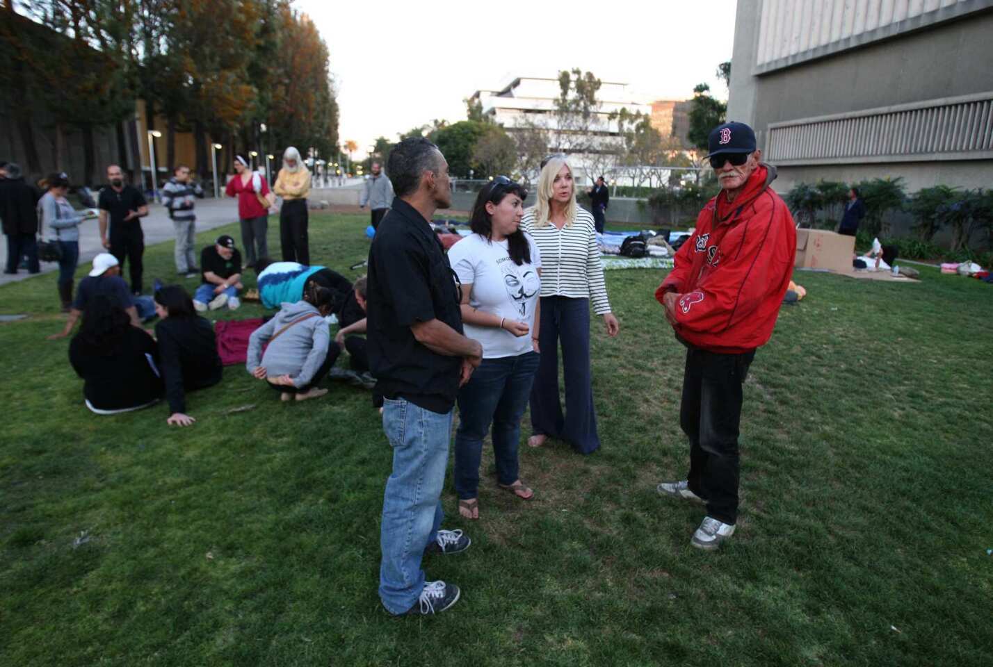 At Necessity Village, Occupy Santa Ana members talk to Jim "Boston" Watson, 66, right, who has been homeless on and off for 30 years.