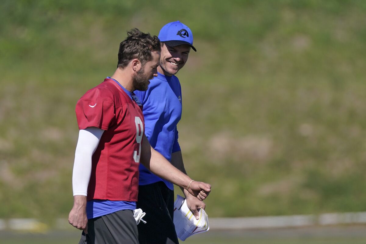 Los Angeles Rams offensive coordinator Kevin O'Connell, right, talks with quarterback Matthew Stafford during practice for an NFL Super Bowl football game Wednesday, Feb. 9, 2022, in Thousand Oaks, Calif. The Rams are scheduled to play the Cincinnati Bengals in the Super Bowl on Sunday. (AP Photo/Mark J. Terrill)