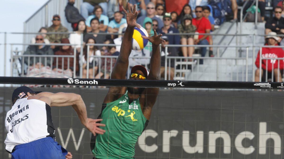 Alexander Brouwer spikes a ball past Evandro Goncalves during the men's final match at the FIVB Huntington Beach Open on May 6.