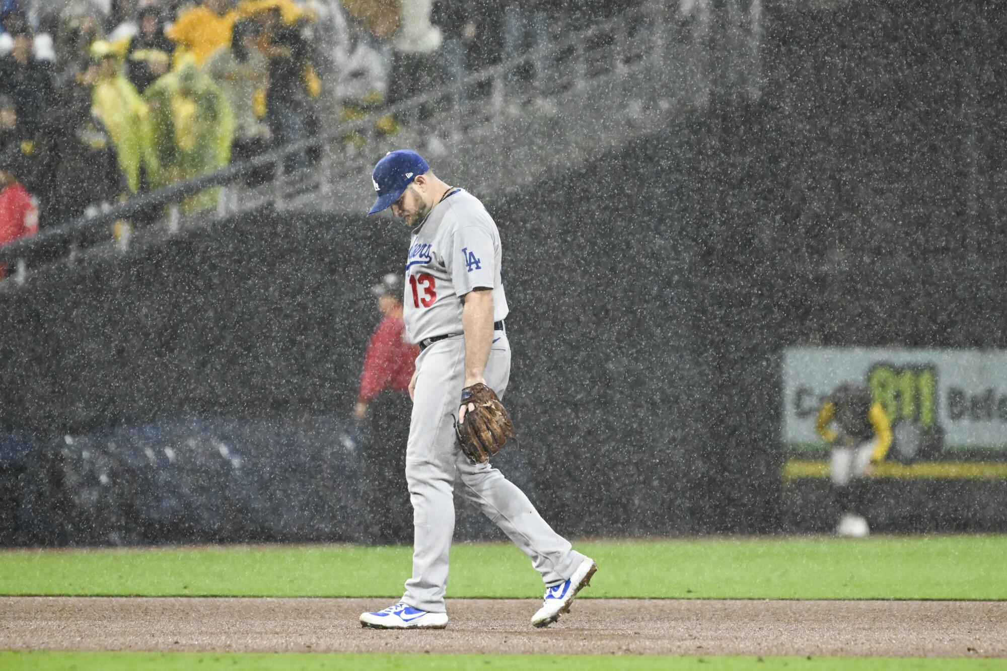 Dodgers second baseman Max Muncy walks on the field in the rain during Game 4 of the NLDS.