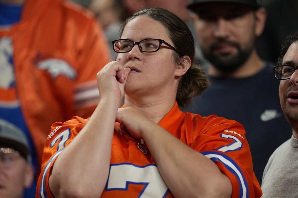 A Denver Broncos fan bites a nail as she watches a game against the Indianapolis Colts.