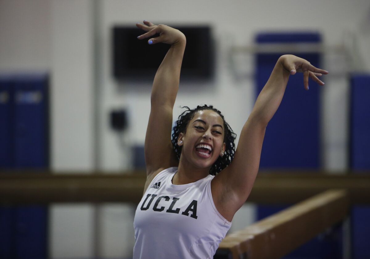 UCLA gymnast Sophina DeJesus finishes a floor exercise move with a flourish and a smile during practice this week. Internet video of DeJesus' floor routine at a meet over the weekend went viral.