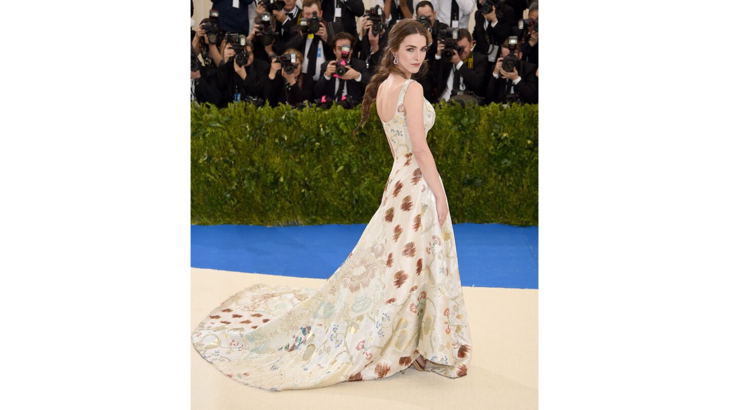 Bee Shaffer an ivory heritage patchwork jacquard evening dress with ivory feather stitching from Alexander McQueen at the 2017 Met Gala.
