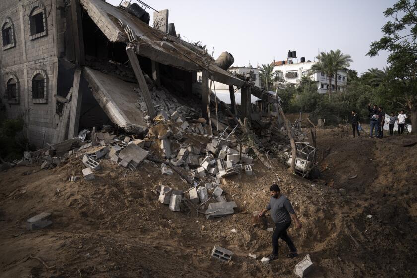 Palestinians inspect the rubble of a house after it was struck by an Israeli airstrike in Deir al-Balah, central Gaza Strip, Friday, May 12, 2023. (AP Photo/Fatima Shbair)