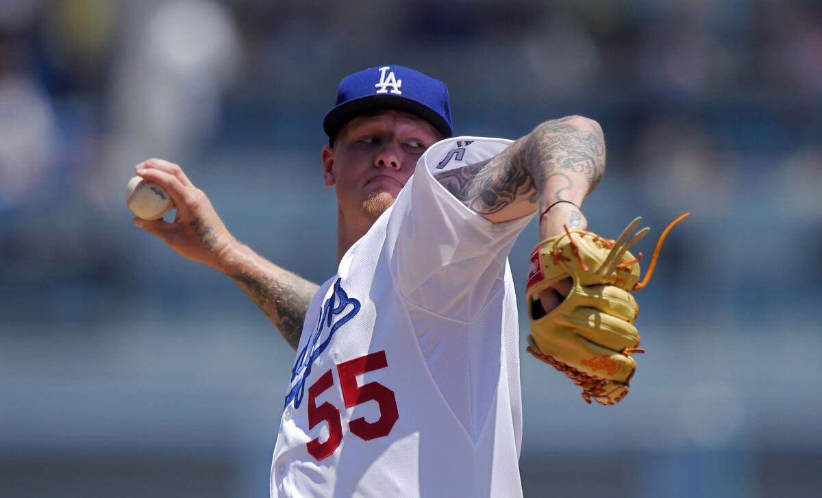 Dodgers starting pitcher Mat Latos throws to the plate during the first inning against the Angels.