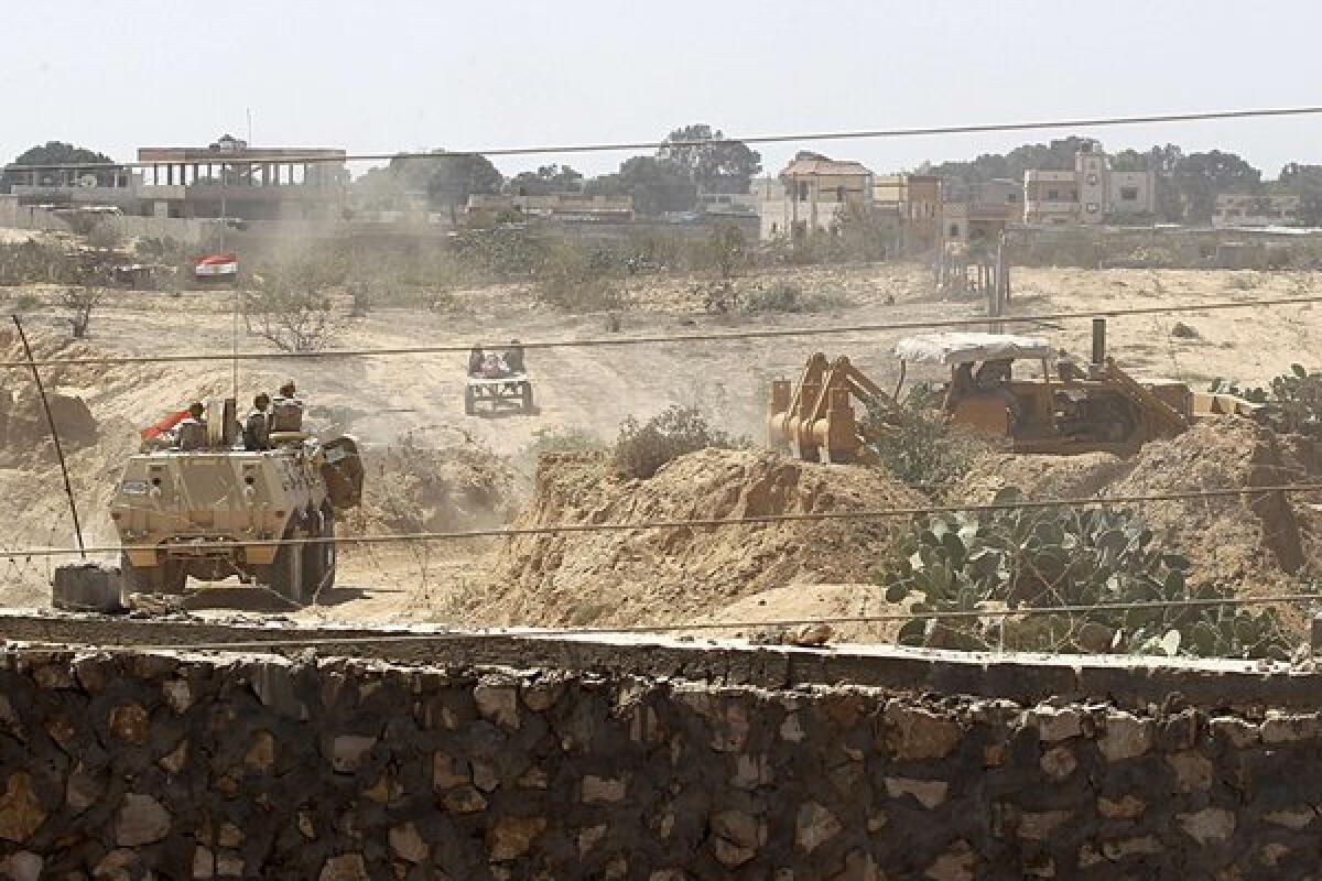 Egyptian soldiers use bulldozers to search for tunnels on the border with the Gaza Strip on Sunday.