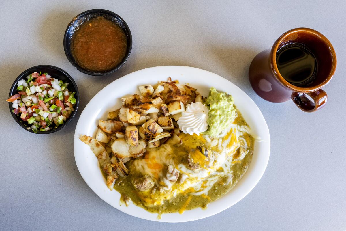 Chile verde omelette with pork simmered in tomatillo sauce, jack and cheddar cheese, served with sour cream and guacamole