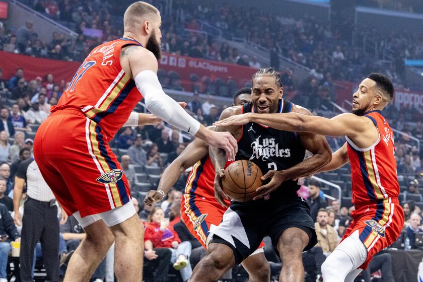 LOS ANGELES, CA - FEBRUARY 7, 2024: LA Clippers forward Kawhi Leonard (2) is double teamed by New Orleans Pelicans center Jonas Valanciunas (17) and New Orleans Pelicans guard CJ McCollum (3) as he drives to the basket in the first half at Crypto.com Arena on February 7, 2024 in Los Angeles, California.(Gina Ferazzi / Los Angeles Times)