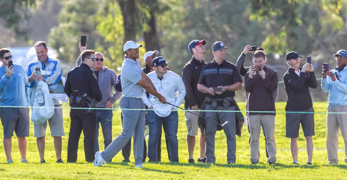 Tiger Woods hits from outside the ropes during the Farmers Insurance Pro-Am event last year at Torrey Pines.
