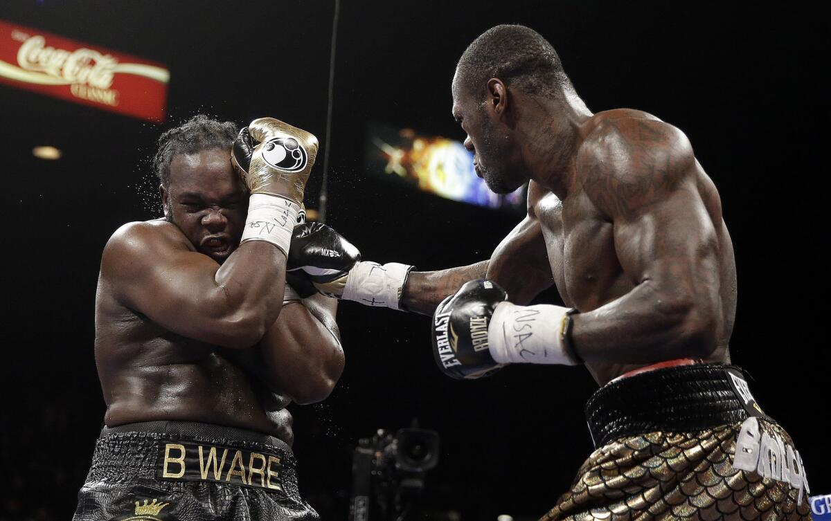 Bermane Stiverne covers up against a barrage from Deontay Wilder during their WBC heavyweight bout.