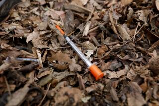 ANAHEIM, CALIF. -- WEDNESDAY, FEBRUARY 14, 2018: A hypodermic needle is found on the ground while U.S. District Judge David Carter surveys the homeless encampment along the Santa Ana River in Anaheim, Calif., on Feb. 14, 2018. Judge Carter ordered on Tuesday, Feb. 20, 2018 at 9:00 A.M. all persons living on the Santa Ana River between Ball Road/Taft Ave and Memory Lane must move out. Temporary motel rooms for a minimum of 30 days will be provided by the County of Orange. The County will clear the county's largest homeless encampment where several hundred people now live. (Gary Coronado / Los Angeles Times)