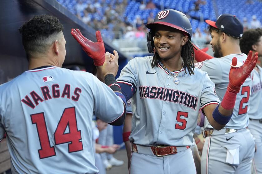 Washington Nationals' CJ Abrams (5) is congratulated by Ildemaro Vargas (14) after hitting a two-run home run during the third inning of a baseball game against the Miami Marlins, Monday, April 29, 2024, in Miami. (AP Photo/Lynne Sladky)