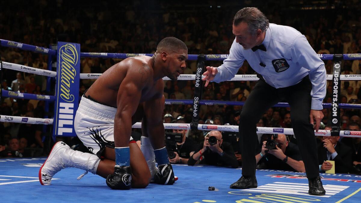 Andy Ruiz Jr. knocks down Anthony Joshua in the seventh round during their IBF/WBA/WBO heavyweight title fight at Madison Square Garden on Saturday in New York.