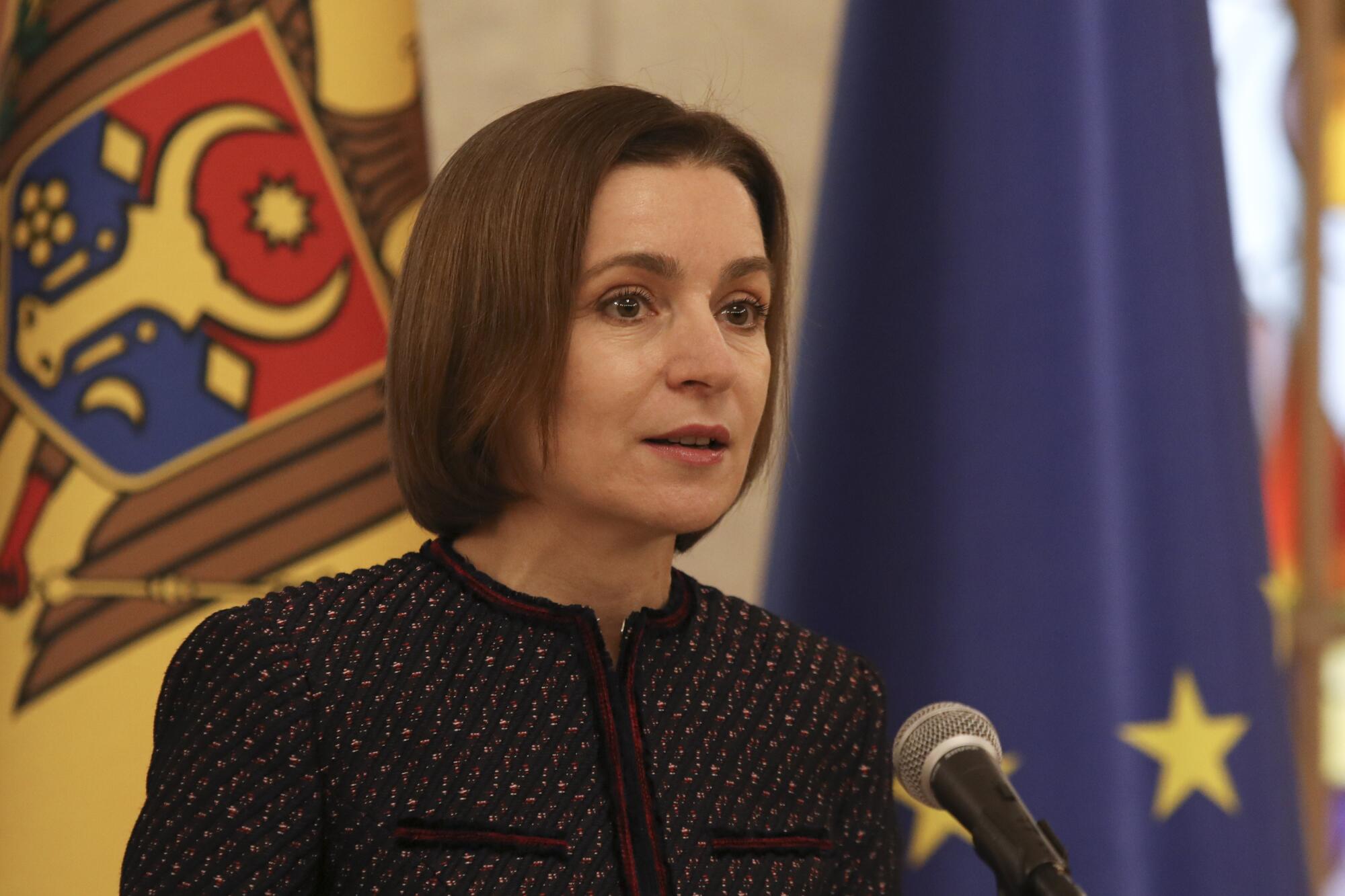 Close-up of Moldovan President Maia Sandu at a microphone.
