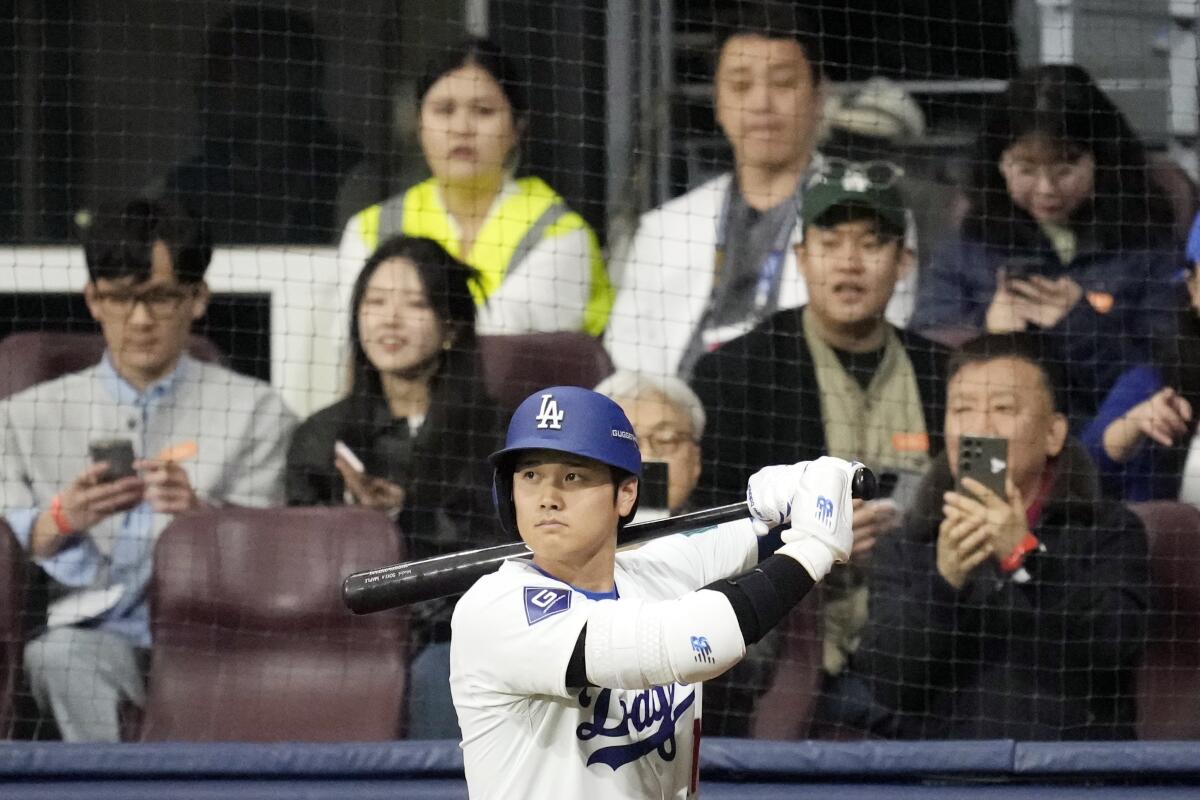 Shohei Ohtani prepares to bat in the first inning of the Dodgers' exhibition game against the Kiwoom Heroes in Seoul.