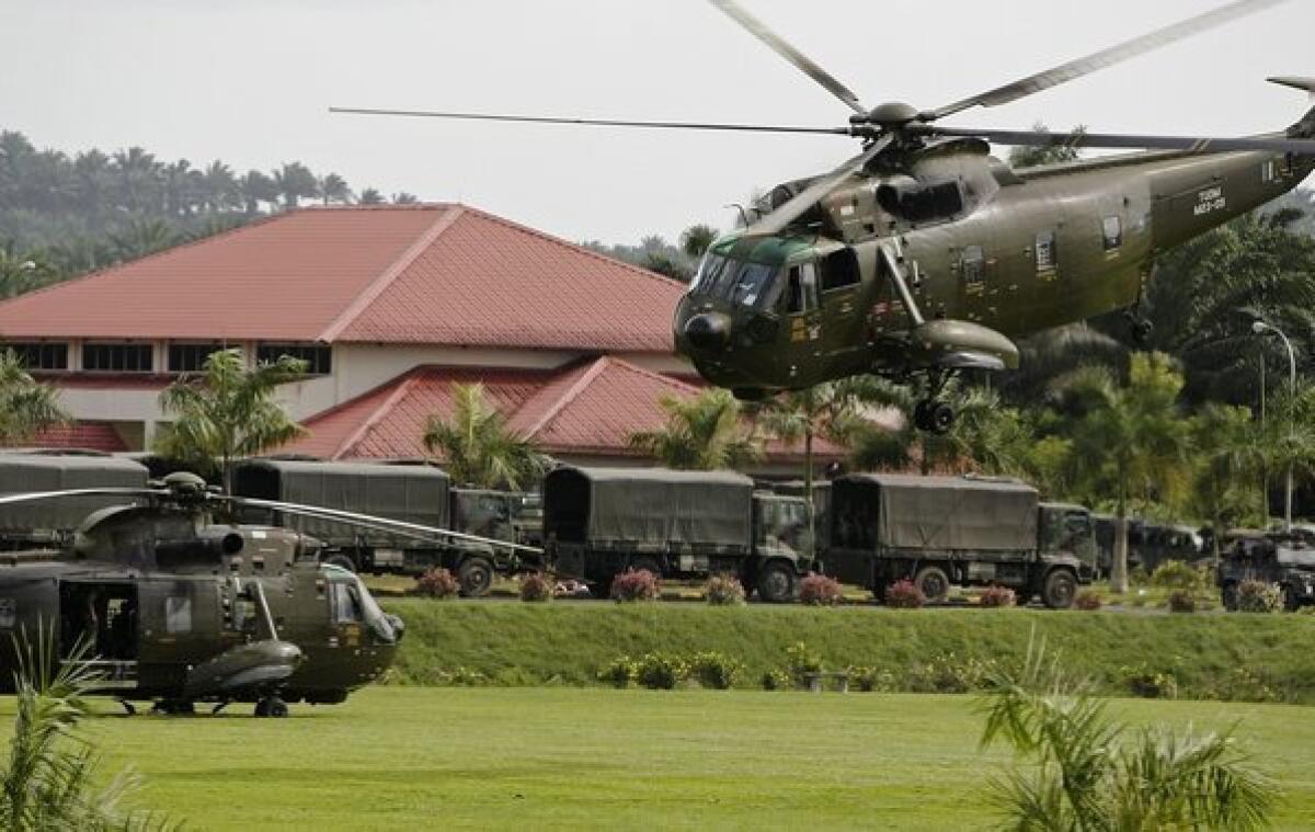 Malaysian helicopters and vehicles are seen at a temporary army base camp at Felda Sahabat in Malaysia's Sabah state on the island of Borneo. Malaysian troops attacked a group of Filipinos that has been occupying a town in the eastern state of Sabah.