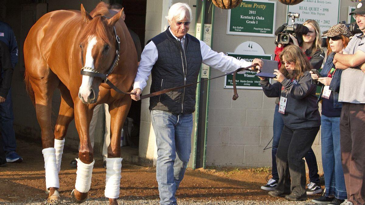 Trainer Bob Baffert leads Justify out of Barn 33 at Churchill Downs the morning after winning the 144th Kentucky Derby in Louisville on Sunday.