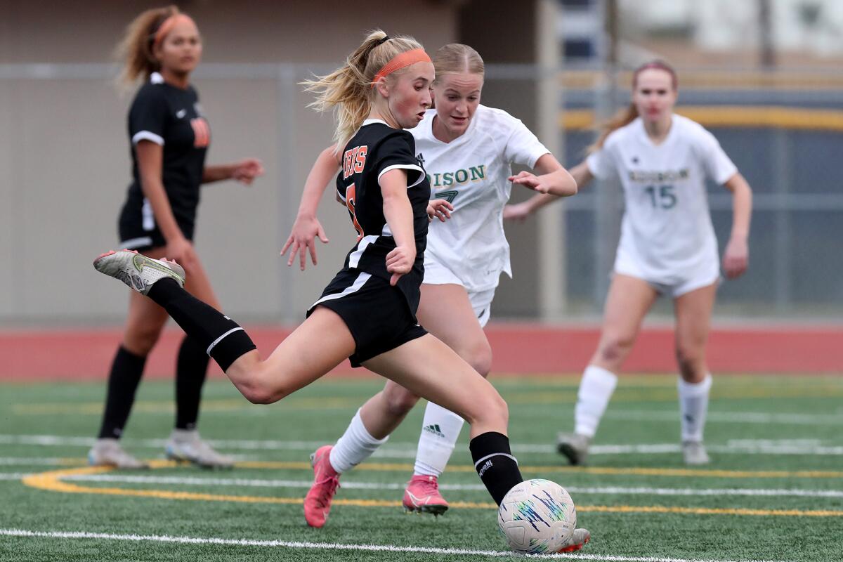 Huntington Beach's Sienna McAthy, center, attempts a shot at the goal during the Best in the West Finals on Saturday.