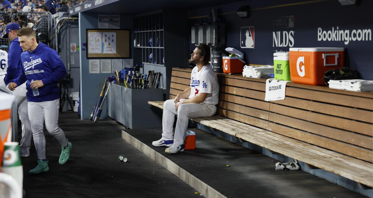 Clayton Kershaw sits in the dugout after being pulled in the first inning of Game 1 of the NLDS.