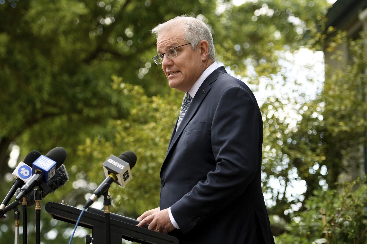 Australia's Prime Minister Scott Morrison speaks during a press conference in Sydney, Friday, Oct. 15, 2021. Morrison confirmed he will attend a climate summit in Glasgow next month while his government remains bitterly divided over a draft plan for the country to achieve net zero emissions by 2050. (Dan Himbrechts/AAP Image via AP)