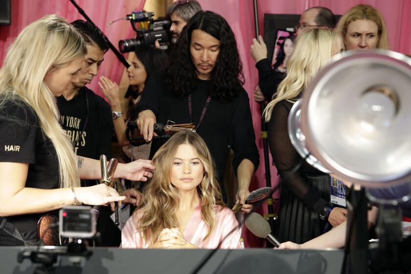 Namibian Victoria's Secret model Behati Prinsloo has her hair and makeup done backstage.